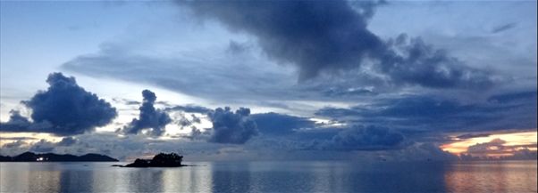 Photograph of sunset and clouds over the ocean